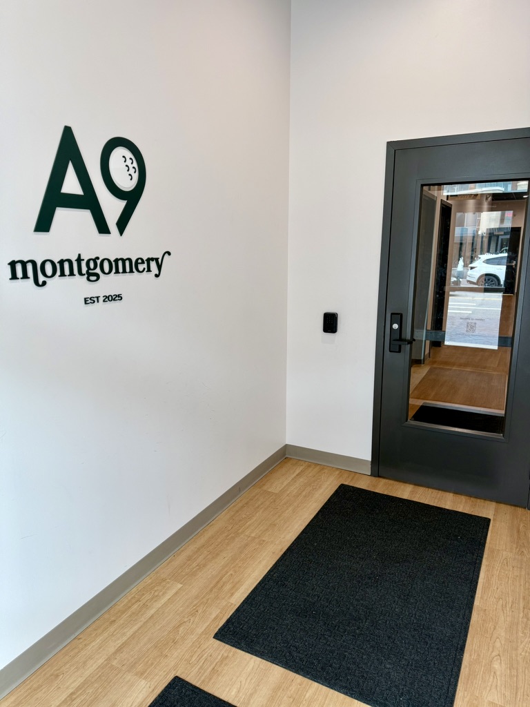 The Another Nine entryway with branded wall signage and keyless front-door access
